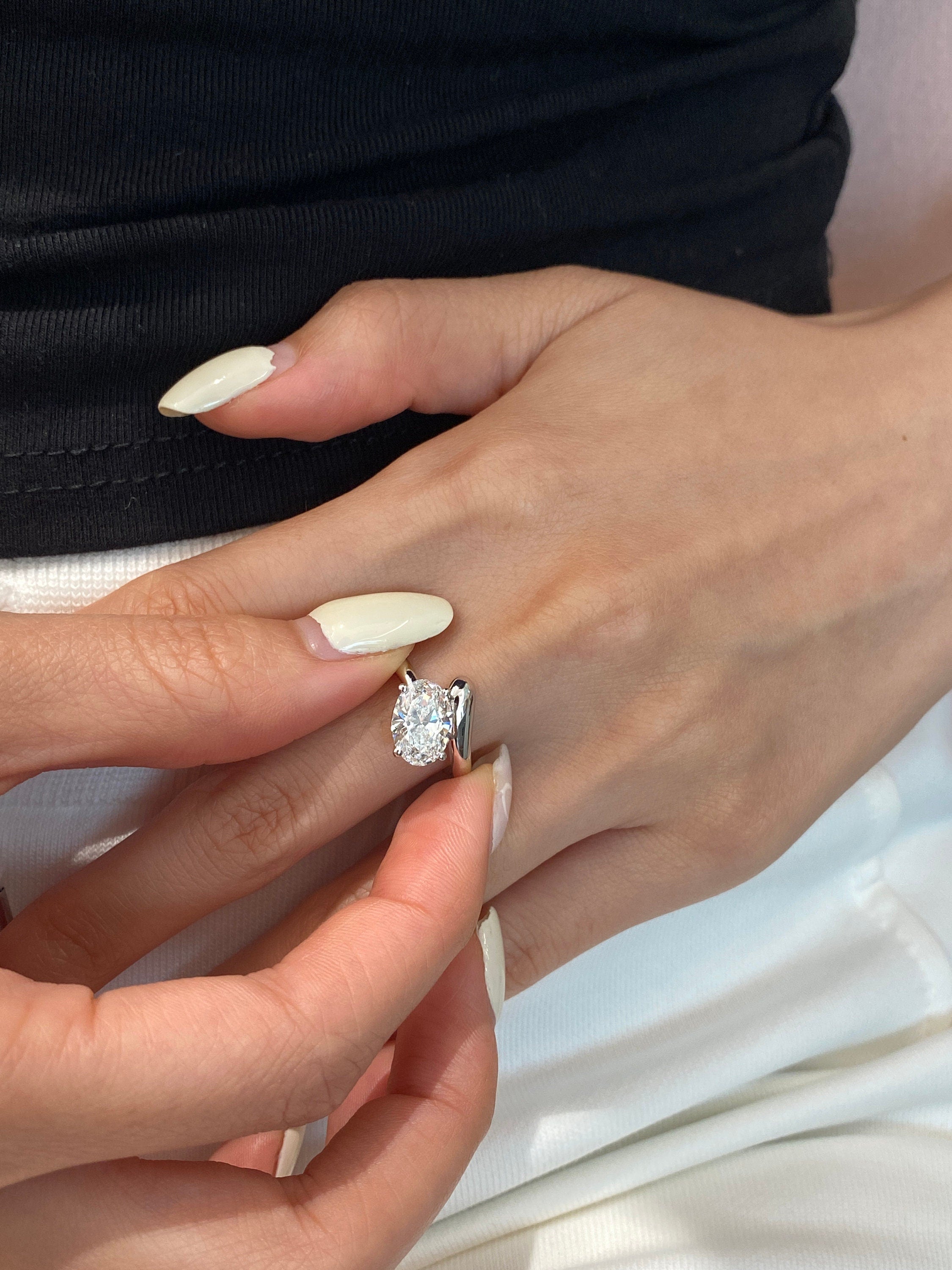 14k gold oval hidden halo lab grown diamond engagement ring, lifestyle shot showing fine craftsmanship
