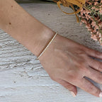 14k gold tennis lab grown diamond bangle bracelet, styled on model showing fine craftsmanship with brilliant sparkle