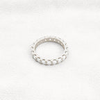 14k gold round lab grown diamond eternity band, top angle view showing fine craftsmanship with brilliant sparkle