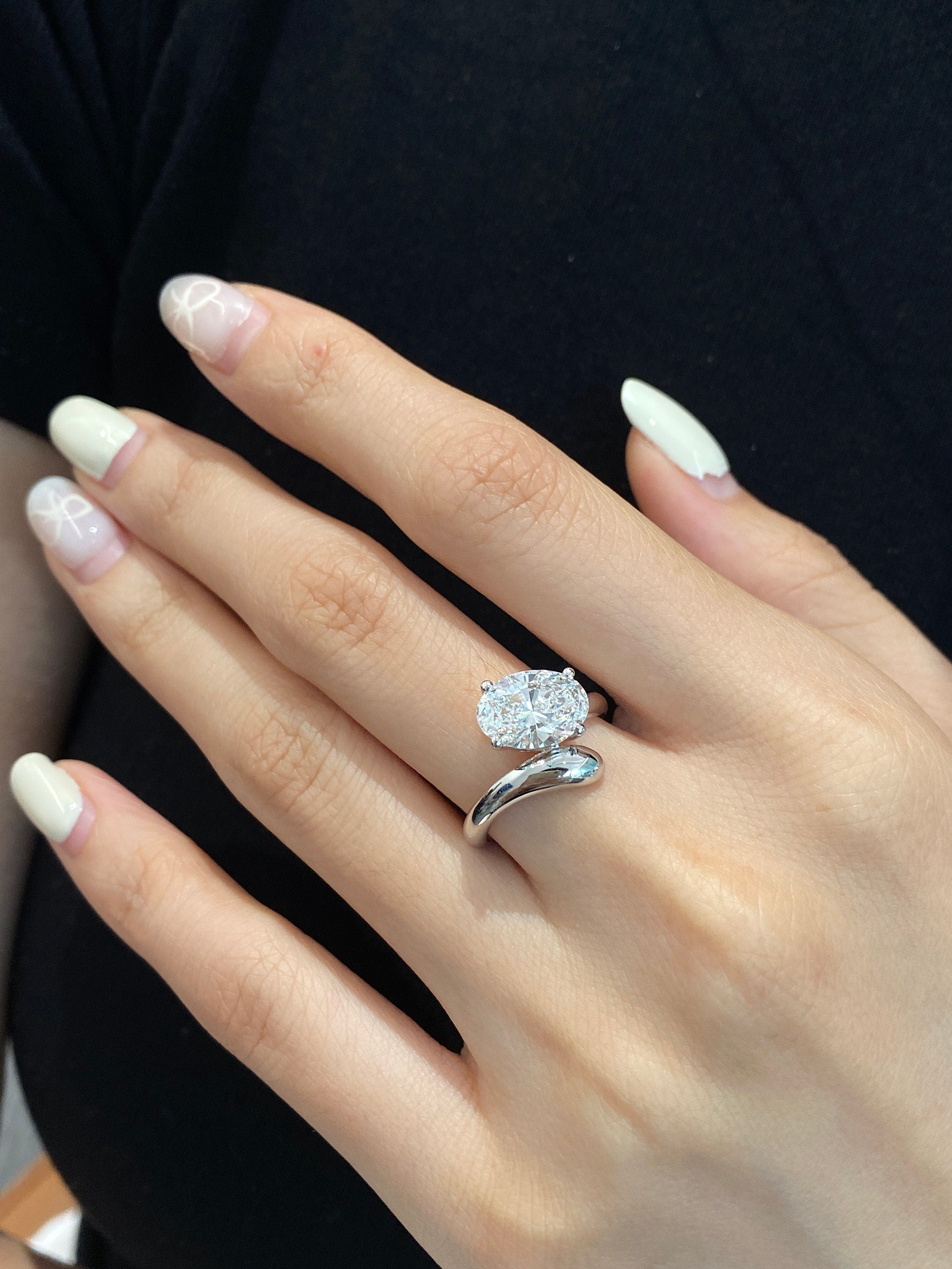 14k gold oval hidden halo lab grown diamond engagement ring, styled on model showing fine craftsmanship