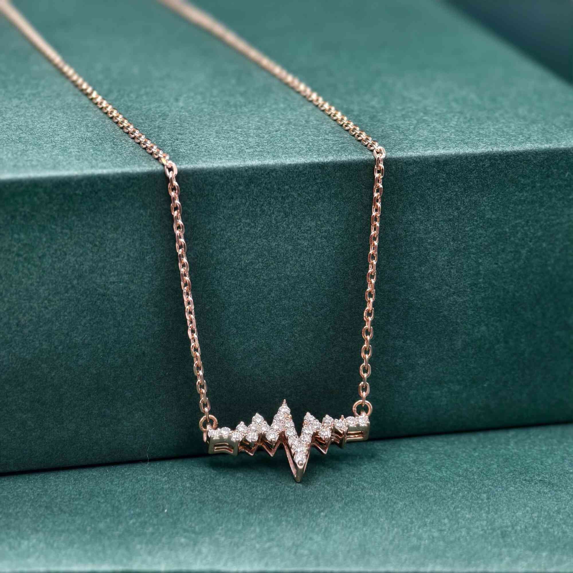 14k gold heartbeat lab grown diamond pendant necklace, top angle view showing fine craftsmanship