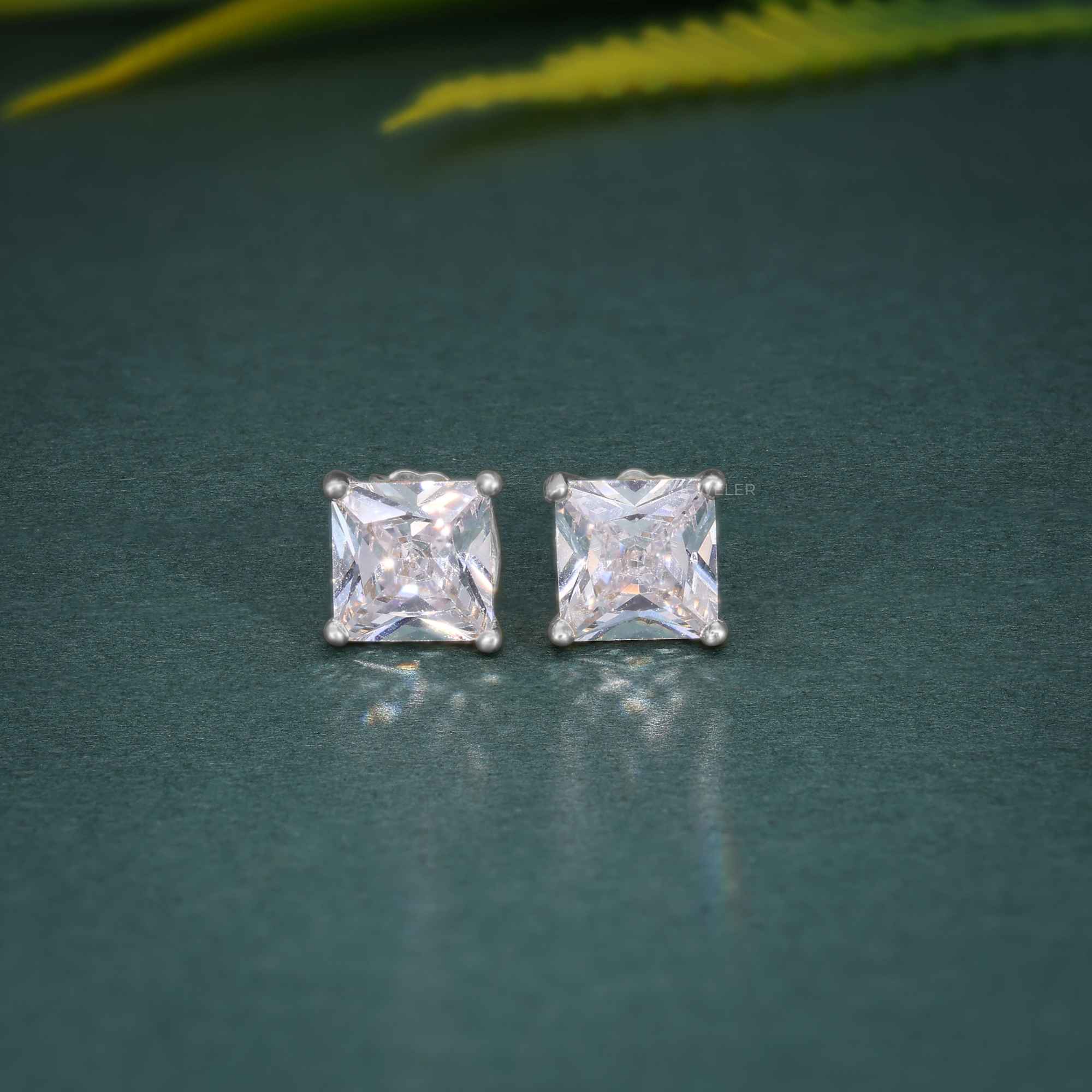 14k gold princess screw back lab grown diamond stud earrings, worn on hand showing fine craftsmanship