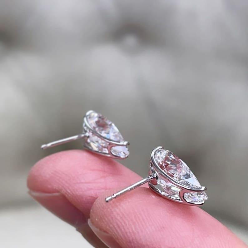 14k gold pear screw back lab grown diamond stud earrings, styled on model showing fine craftsmanship