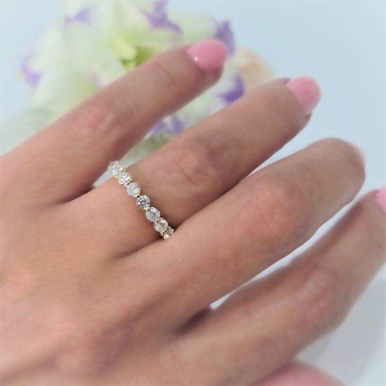 14k gold round lab grown diamond eternity band, detailed close-up showing fine craftsmanship