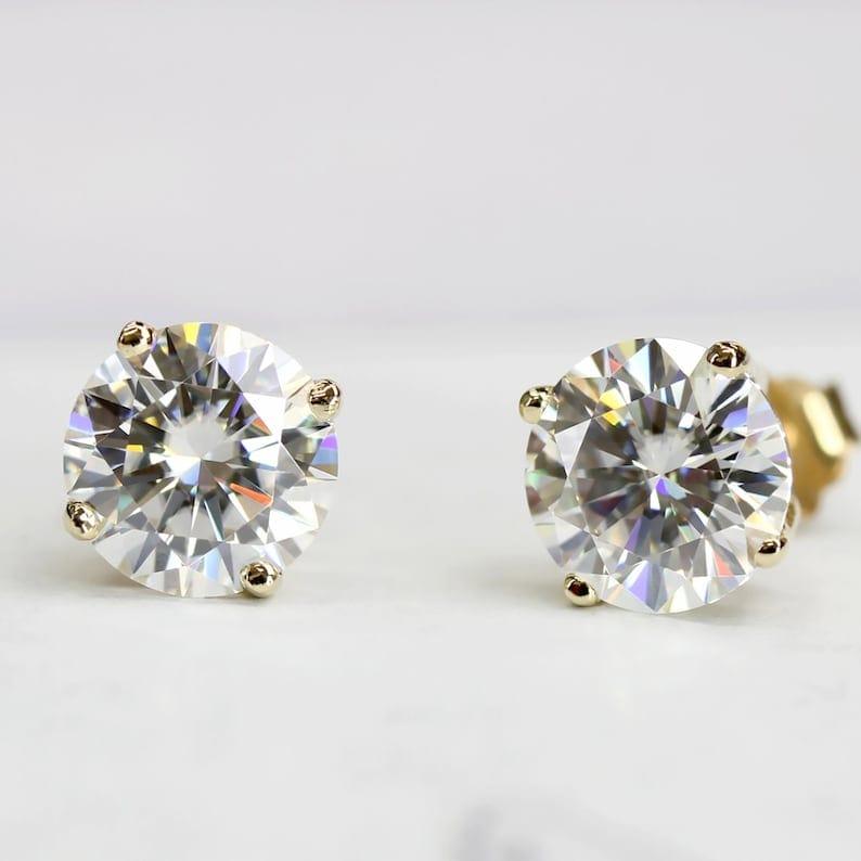 14k gold round prong-set lab grown diamond stud earrings, worn on hand showing fine craftsmanship